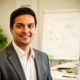 Friendly database consultant standing beside a whiteboard with schema notes in a bright office